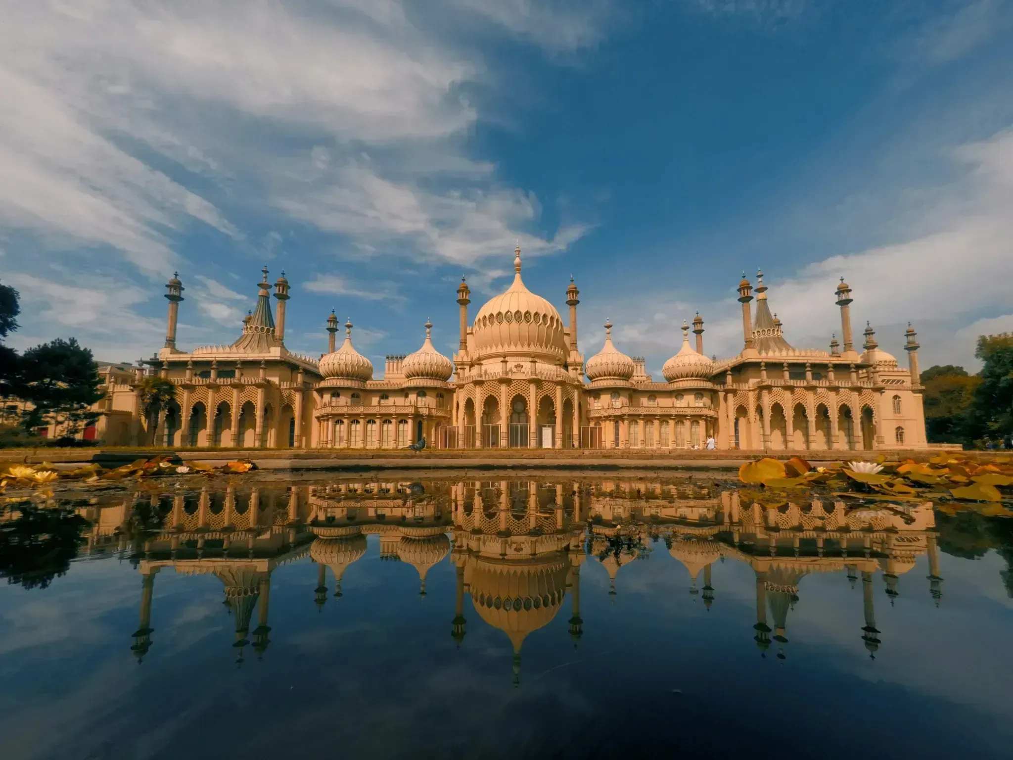 Royal Pavilion in Brighton reflected in a pond at dusk.