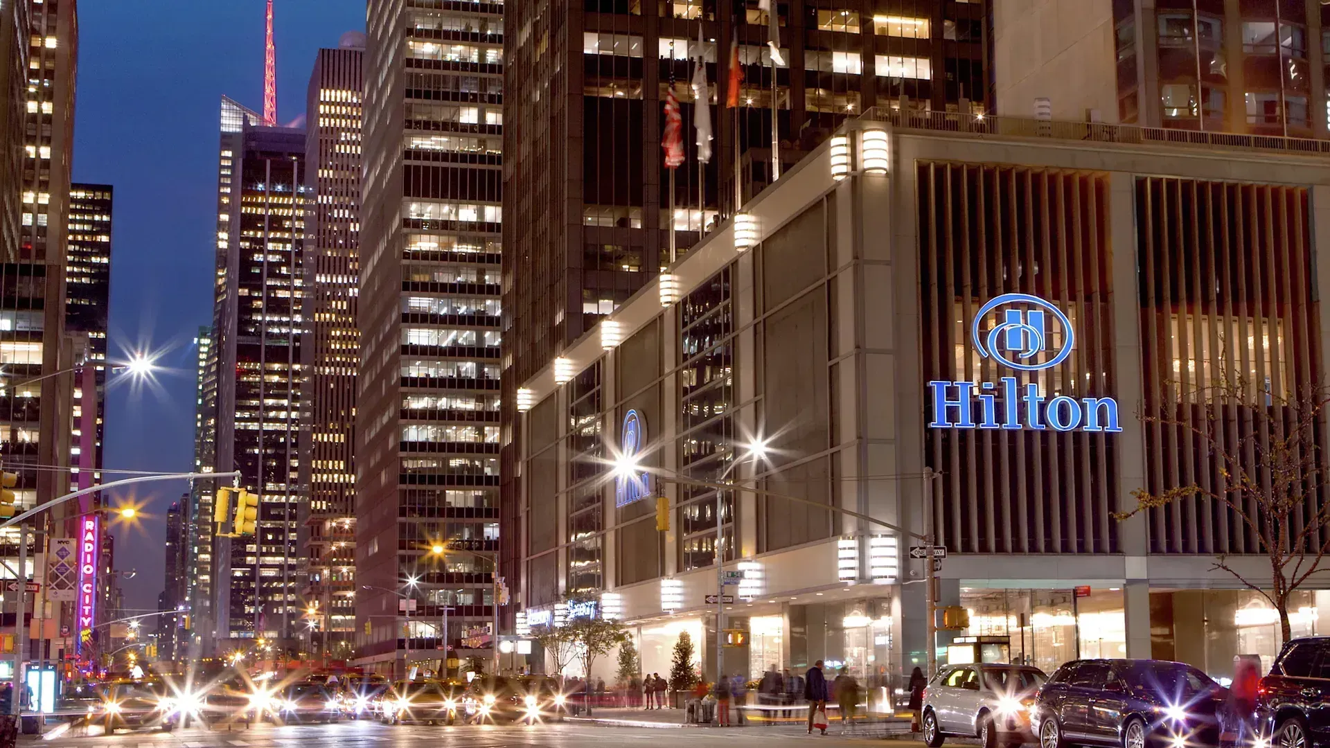 Nighttime street view of the Midtown Hilton in New York City.