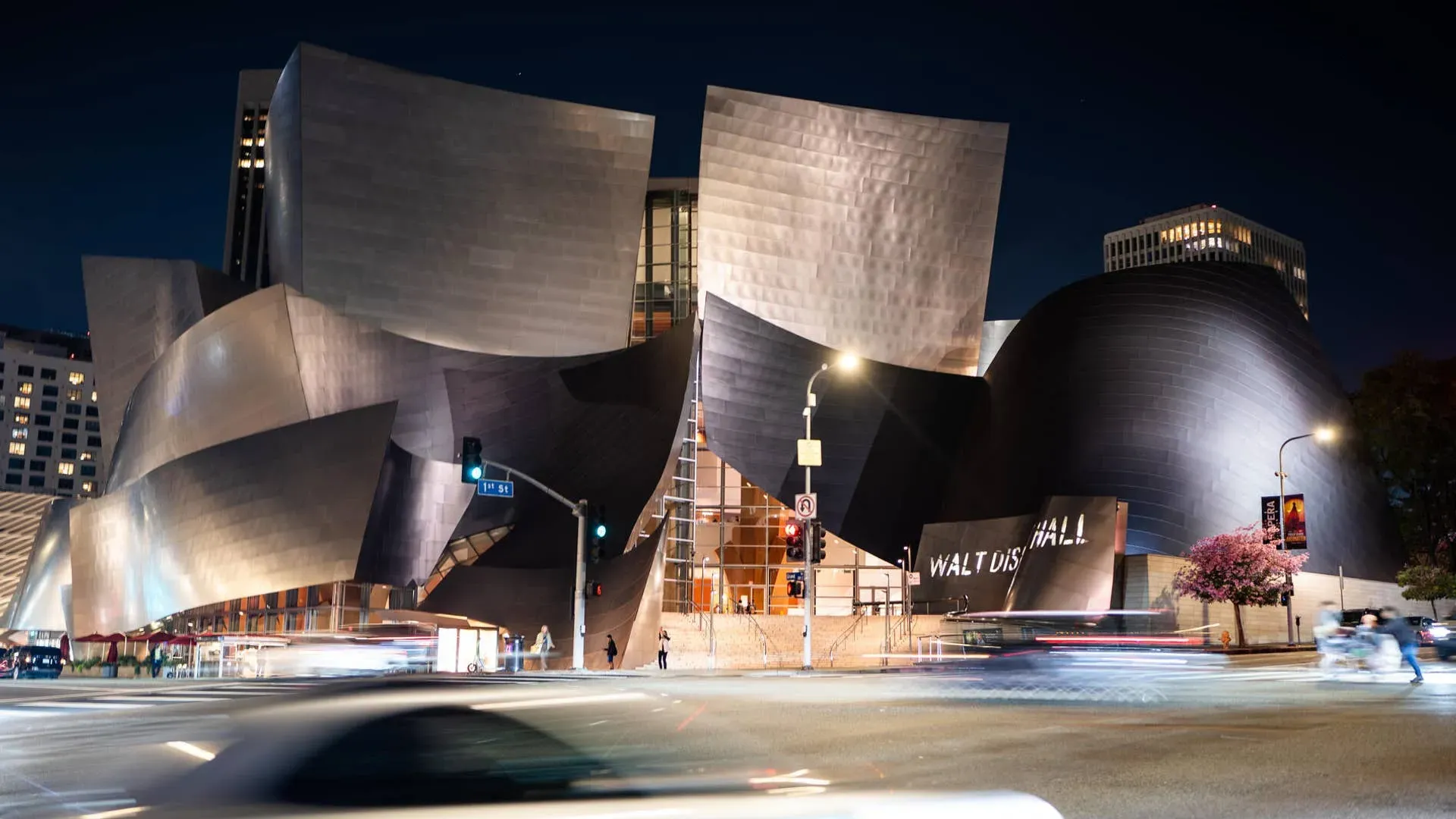 Walt Disney Concert Hall illuminated at night in downtown Los Angeles.