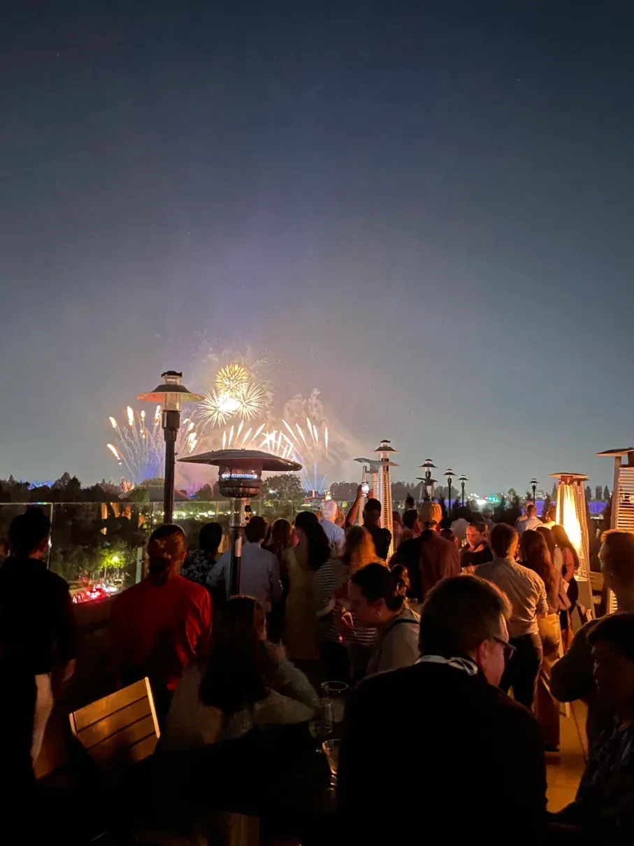Conference attendees gathered outdoors at night in Anaheim.