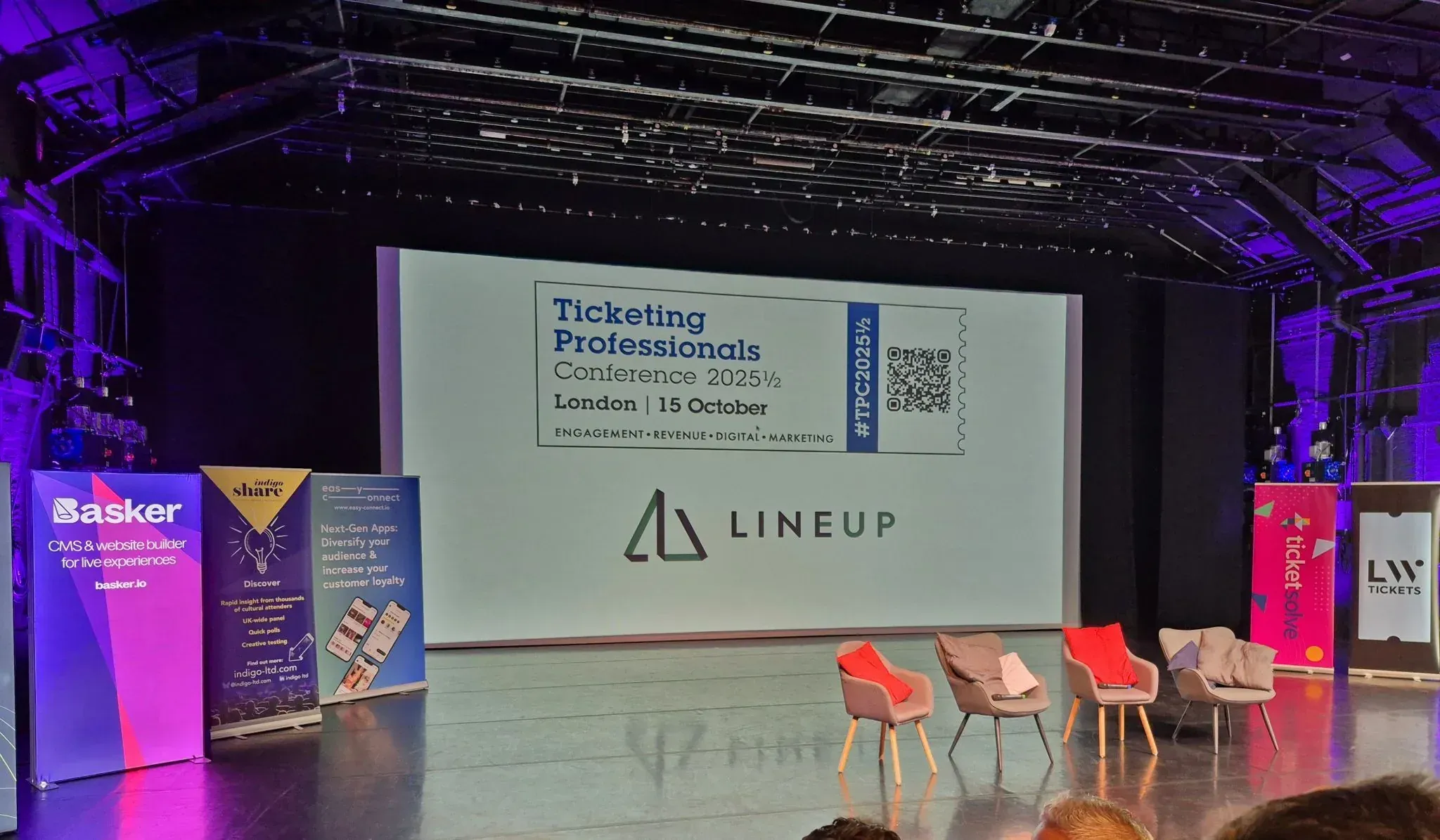 Ticketing Professionals Conference stage with Basker banners and sponsor logos.